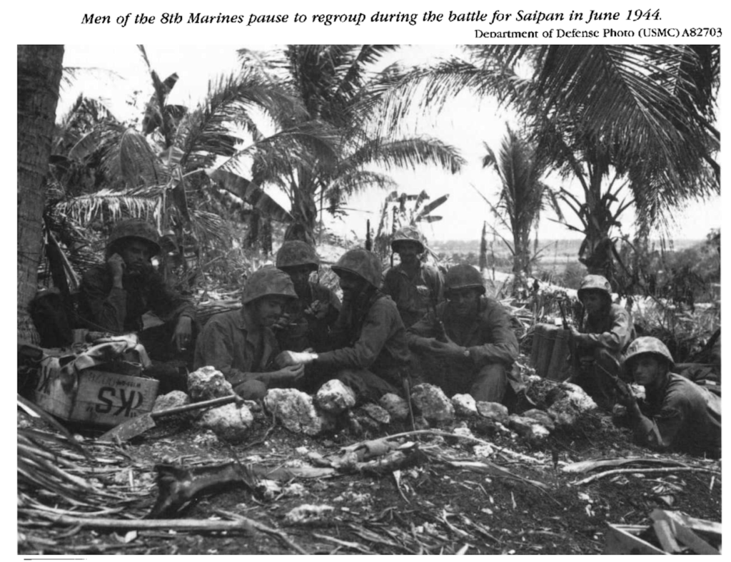 Marines sitting on the ground in Saipan.