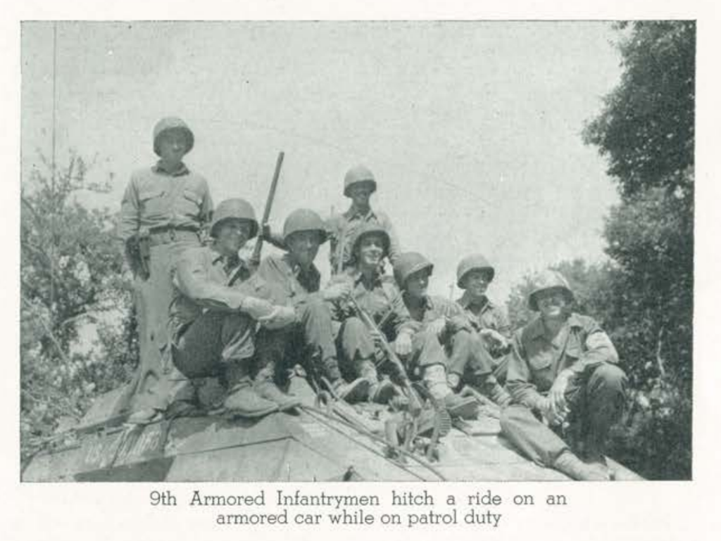 9th Armored Infantrymen hitch a ride on an armored car while on patrol duty